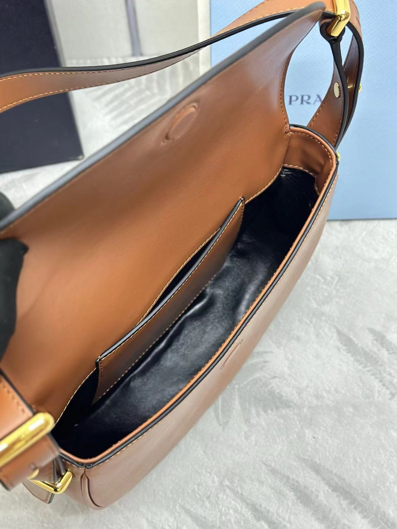 Prada Arqué leather shoulder bag with flap