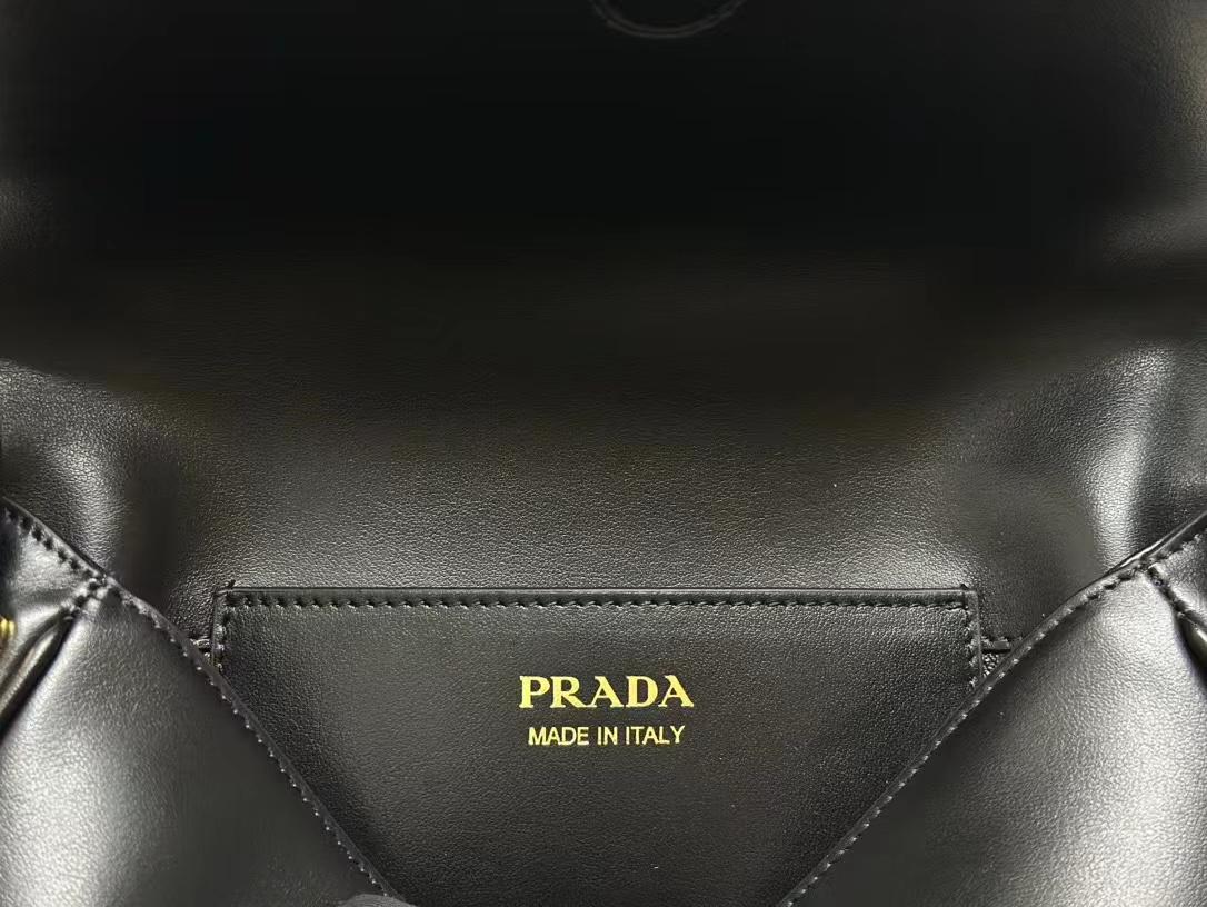 Prada Arqué leather shoulder bag with flap