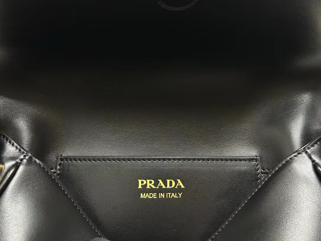 Prada Arqué leather shoulder bag with flap
