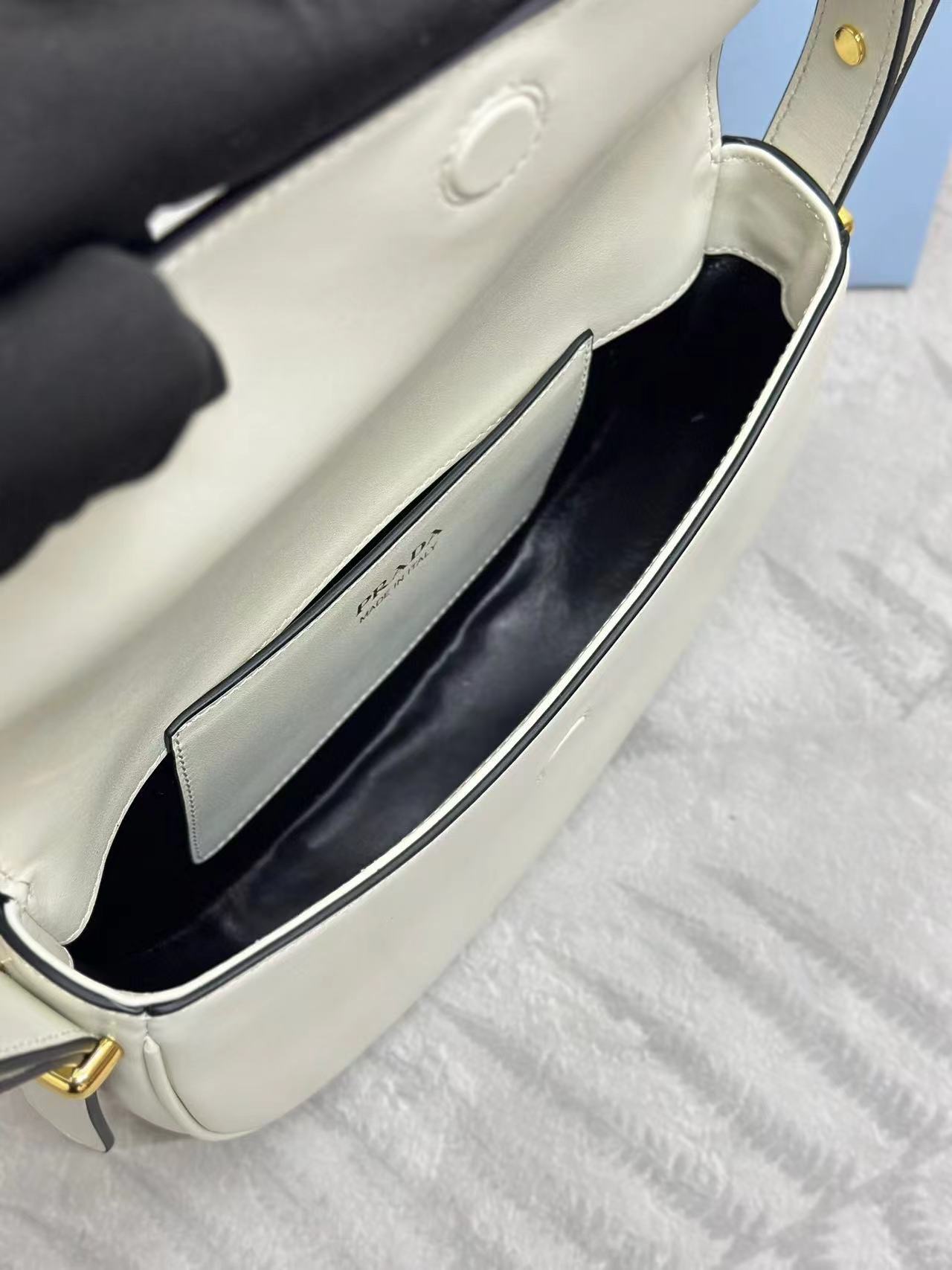 Prada Arqué leather shoulder bag with flap