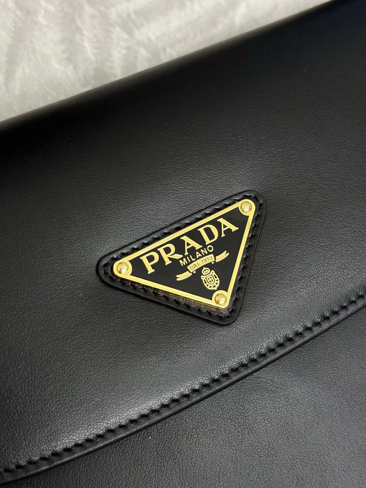 Prada Arqué leather shoulder bag with flap