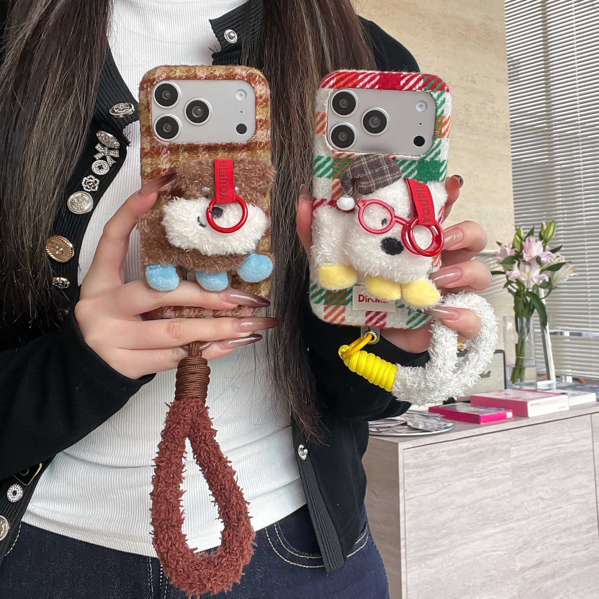 Cute plush dog-shaped phone case with lanyard for iPhone.