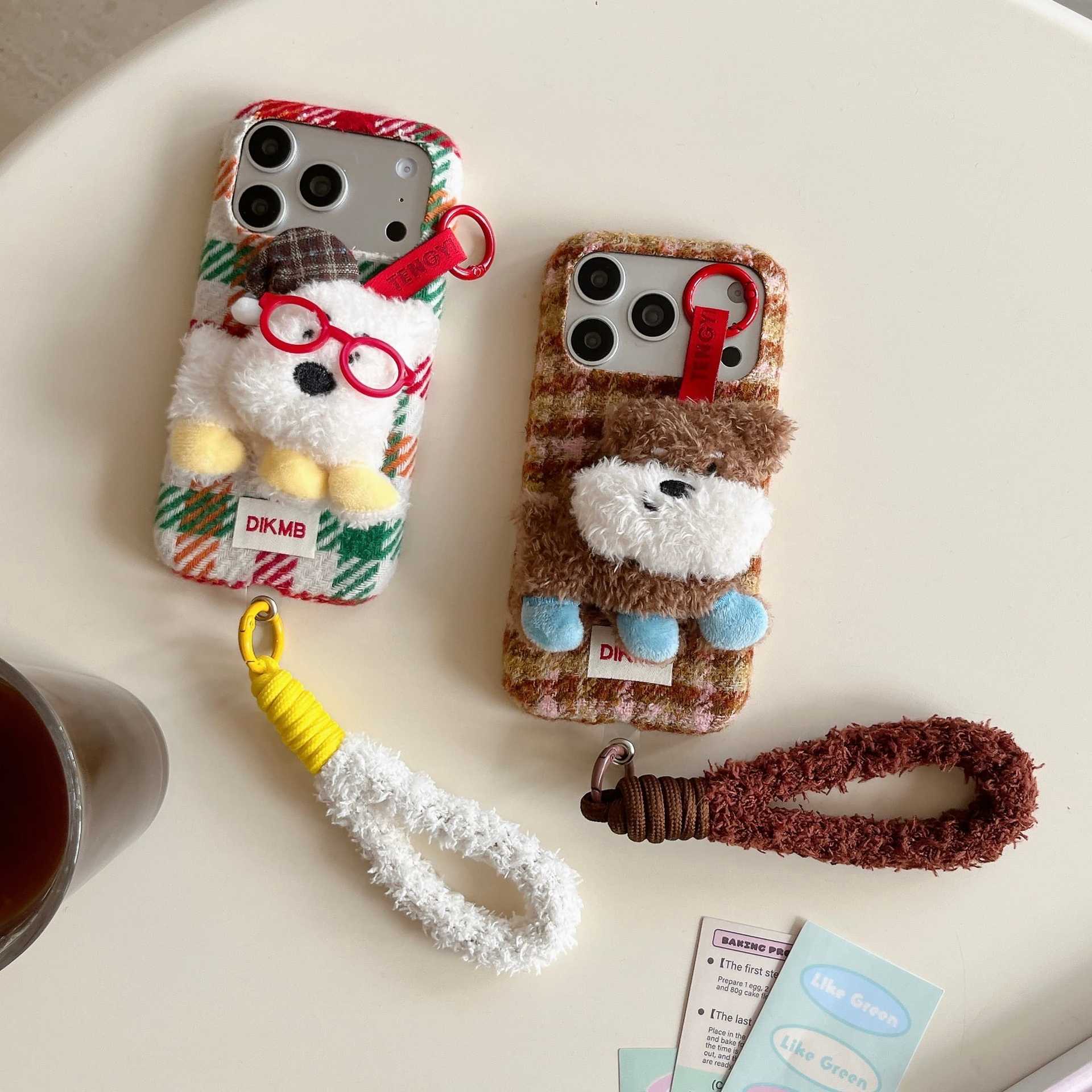 Cute plush dog-shaped phone case with lanyard for iPhone.