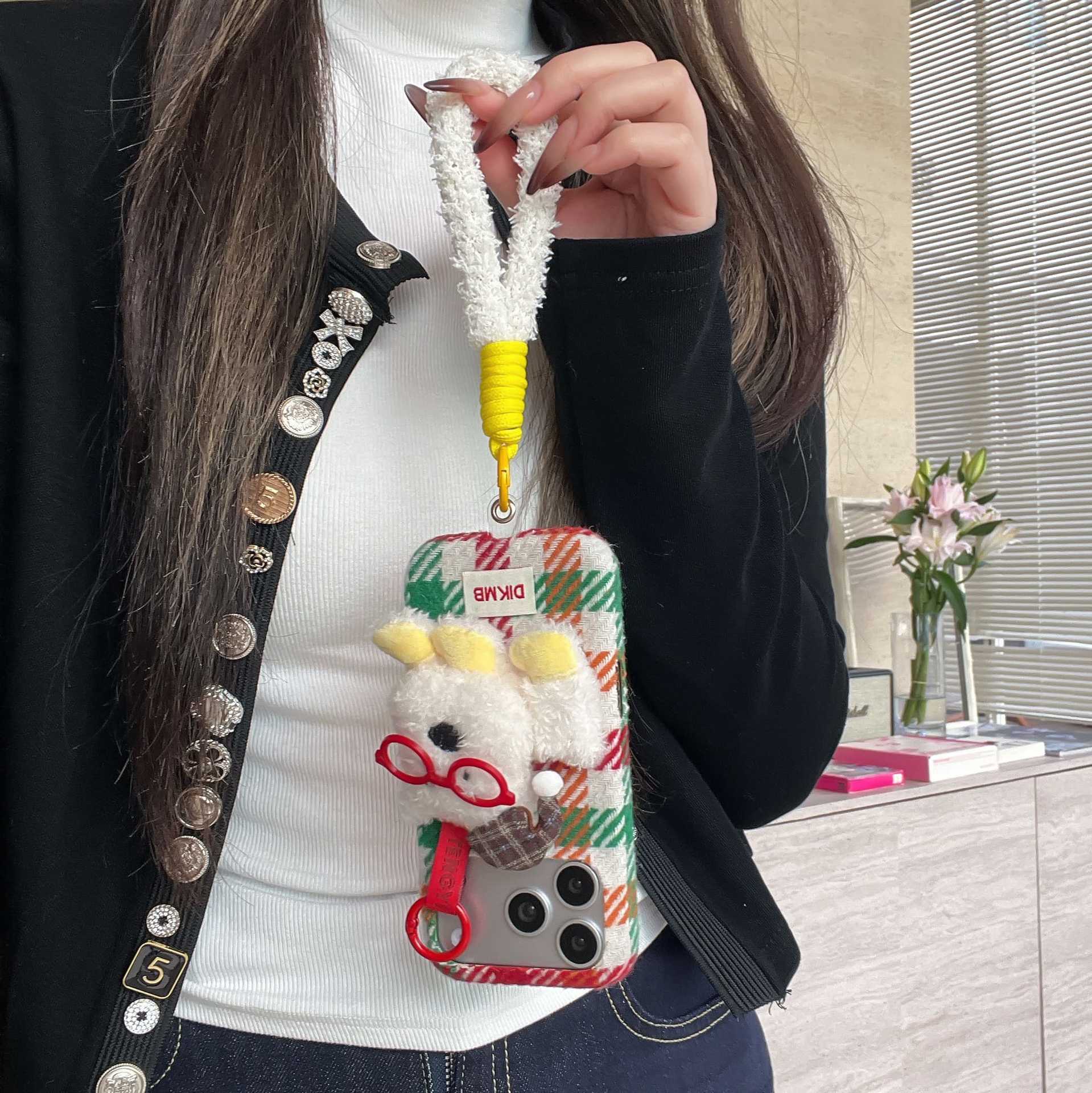 Cute plush dog-shaped phone case with lanyard for iPhone.