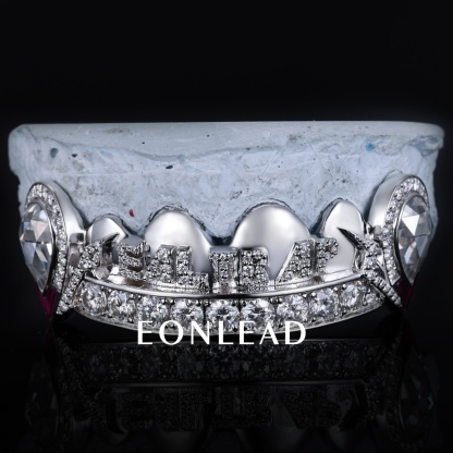 Custom Iced Out "REAL" Letter Top Grillz 925 Silver Plated 10K Gold Teeth Grillz Teardrop Diamond Ruby Enamel Fangs Hip Hop Dental Grills For Men Women Rapper Jewelry