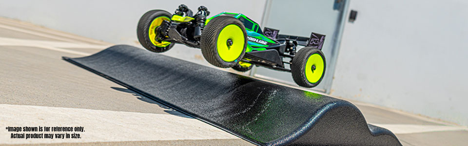 Action shot of an RC Car jumping off of the Pro-Line Double Hump RC Ramp
