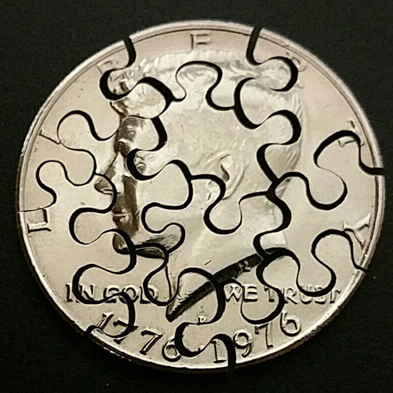 Puzzle cut from a Kennedy half dollar