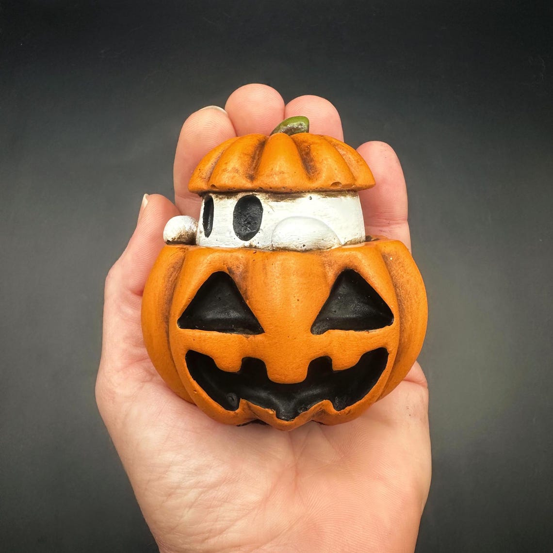 Spooky cute pumpkin ghost has been painted to resemble a spooky little s'more! Ghost looks like a little marshmallow smushed between a pumpkin with a white body, orange jack-o-lantern with brown distressing pulling together his s'more-like look!