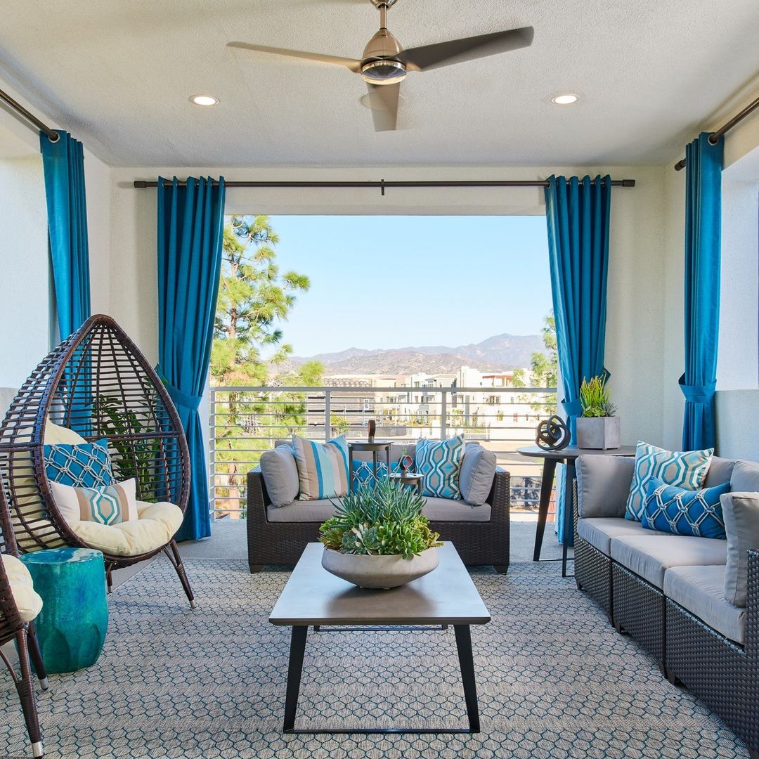 Light-colored Outdoor Curtains beside a shaded patio seating area