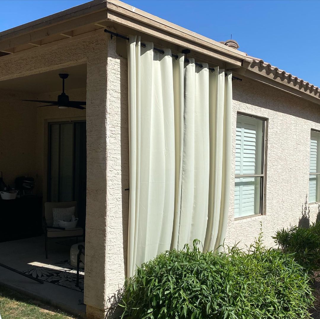 Outdoor curtains providing flexible shade on a sunny patio