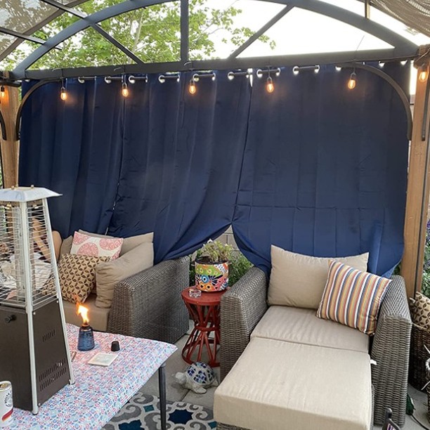 Outdoor privacy curtains providing flexible coverage on a patio