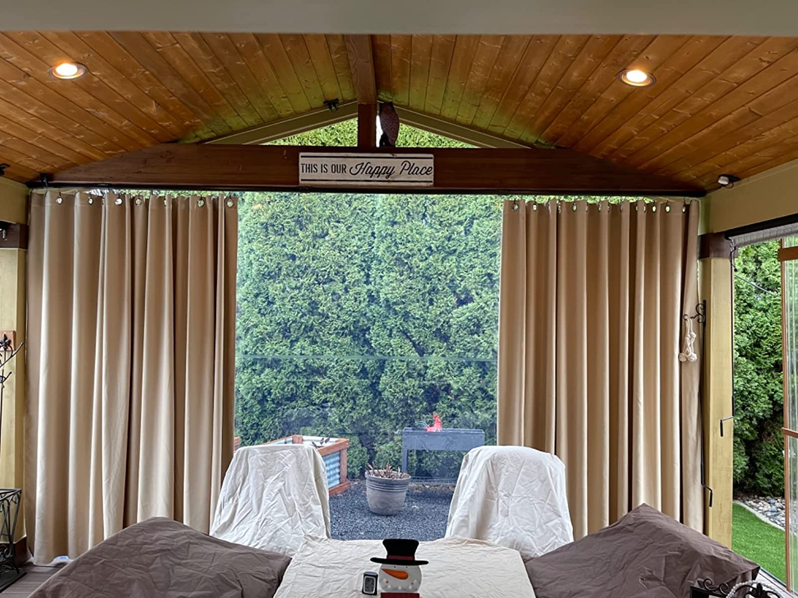 Outdoor curtains arranged on a covered patio with practical wind-aware support