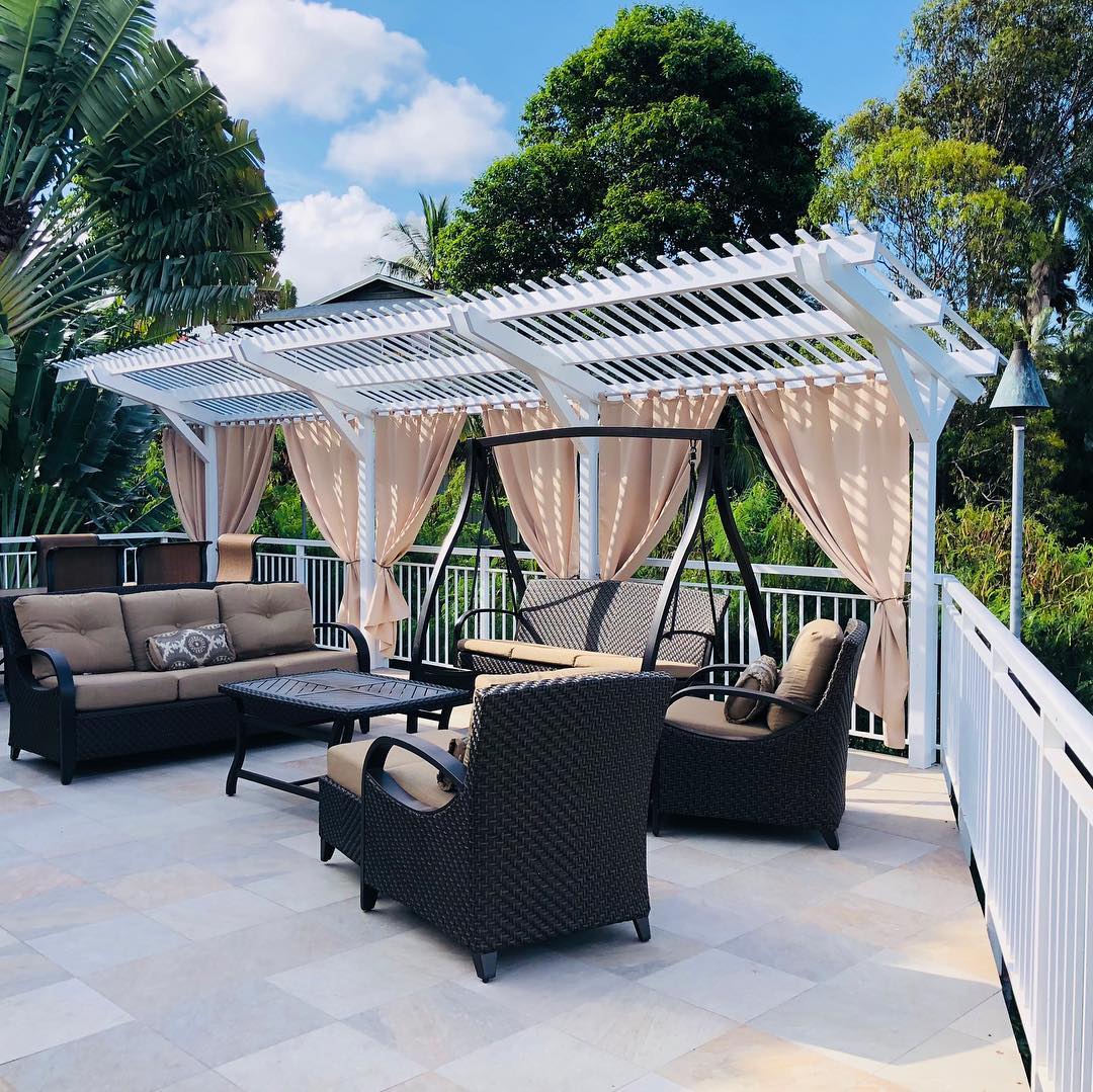 Beige outdoor curtains framing a covered patio