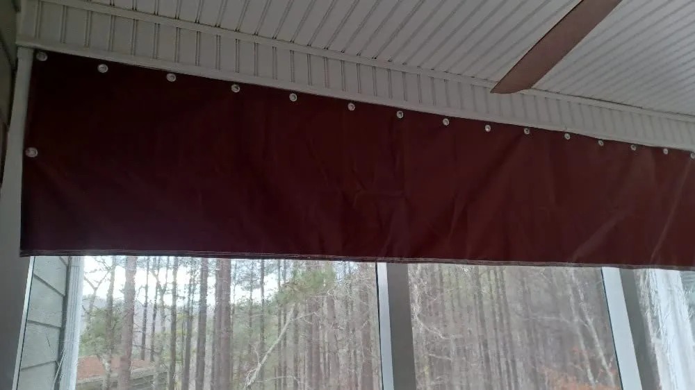 Clear vinyl patio curtain panel at a covered outdoor seating area