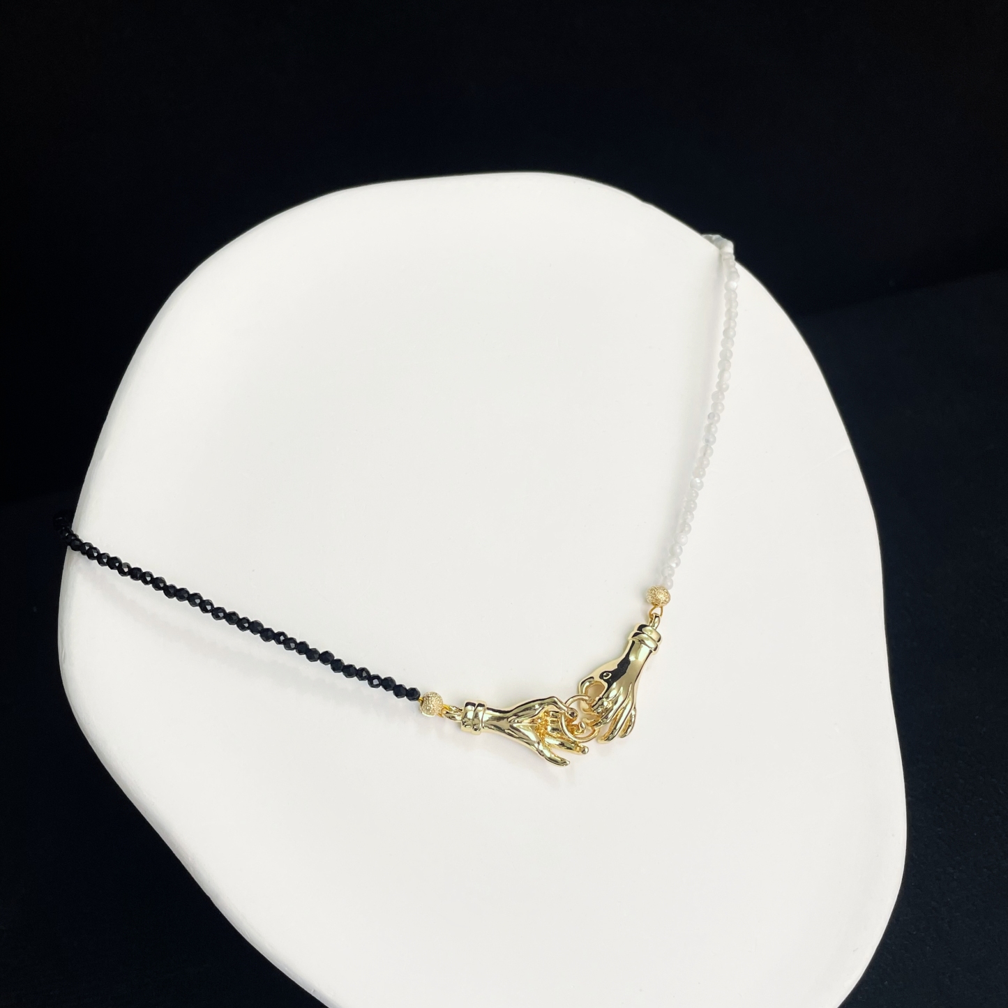 Asymmetrical Black and White Hand-in-Hand Necklace