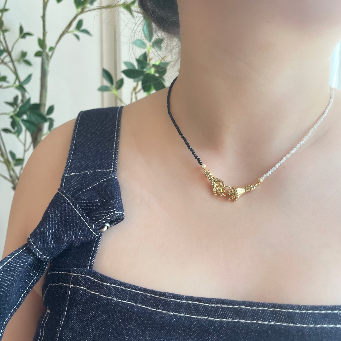 Asymmetrical Black and White Hand-in-Hand Necklace