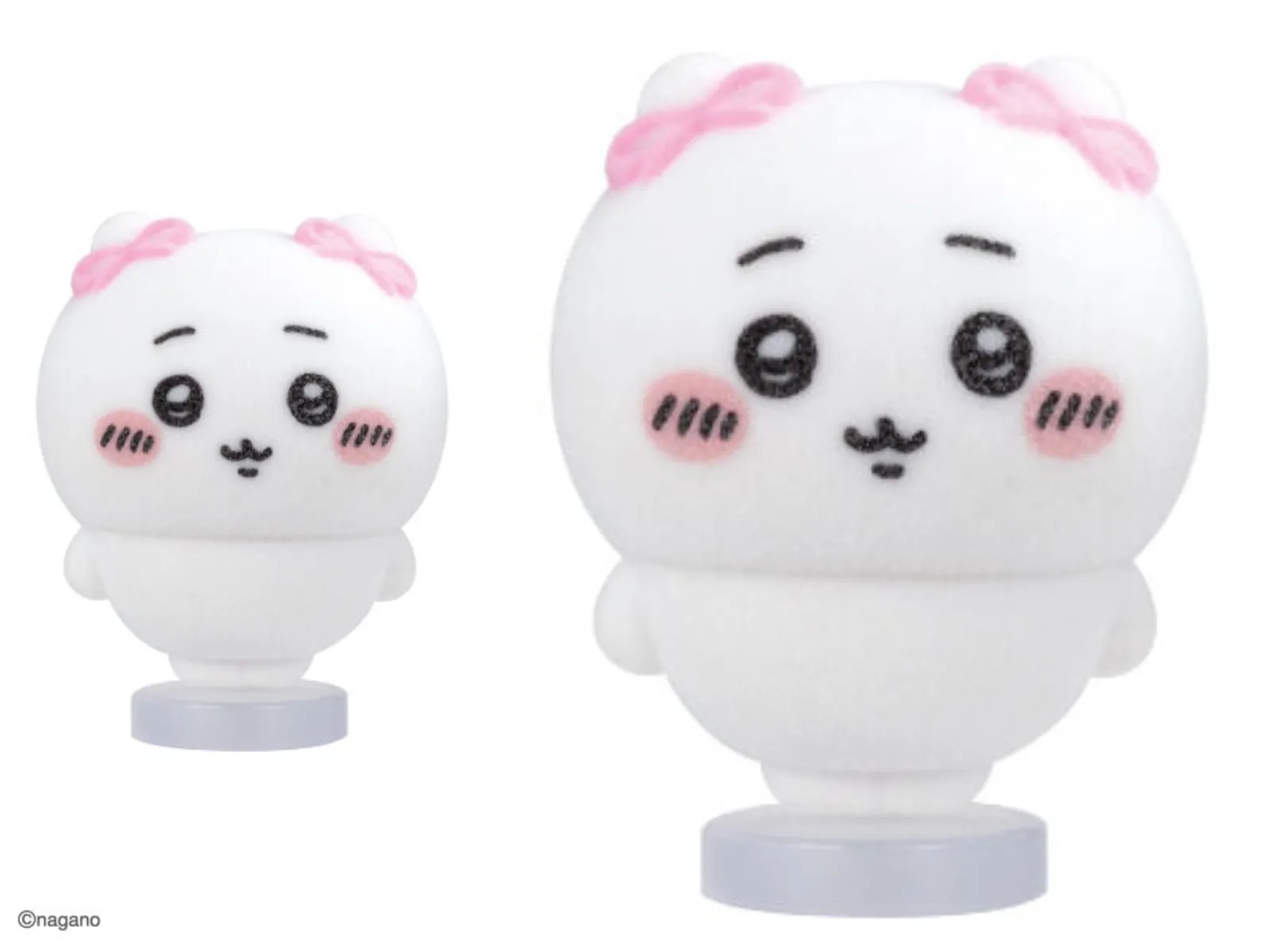 Chiikawa Fluffy Flocky Doll with soft flocked finish and pink ribbons on its ears, shown on a clear base