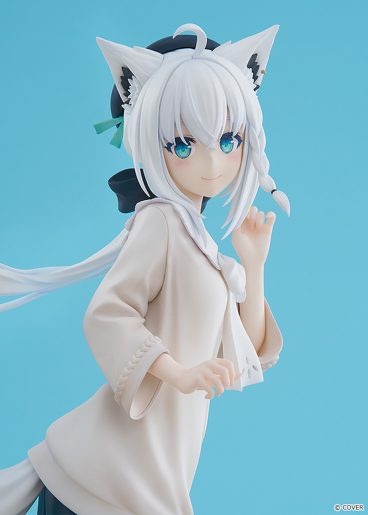 Close-up of the Fubuki figure with clear blue eyes, white fox ears, a dark hair accessory with green ribbons and long white hair flowing to one side