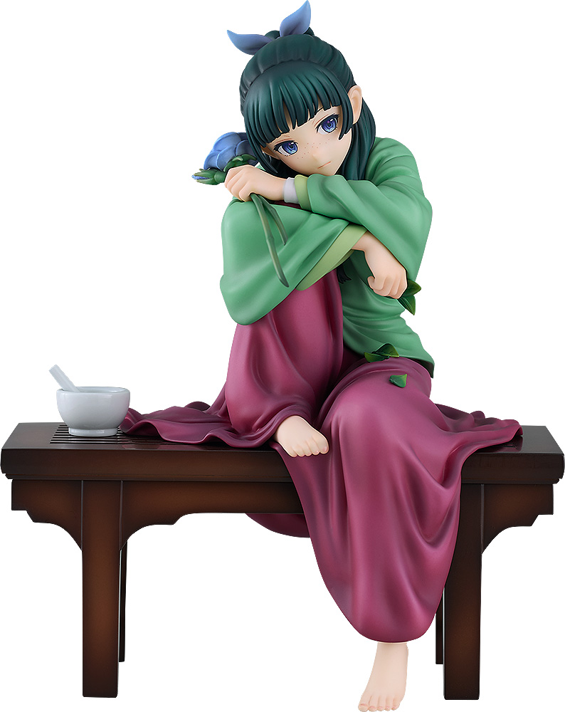 G.S. Collection Maomao 1/7 figure on a white background, sitting on a low dark wooden bench hugging her knees, in a green jacket and magenta skirt, with a white mortar beside her