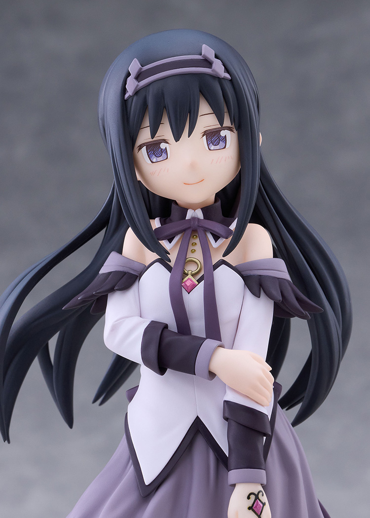 Close-up of the Akemi Homura figure with long black hair, purple eyes and a lilac headband, one hand raised to her chest and the other arm folded