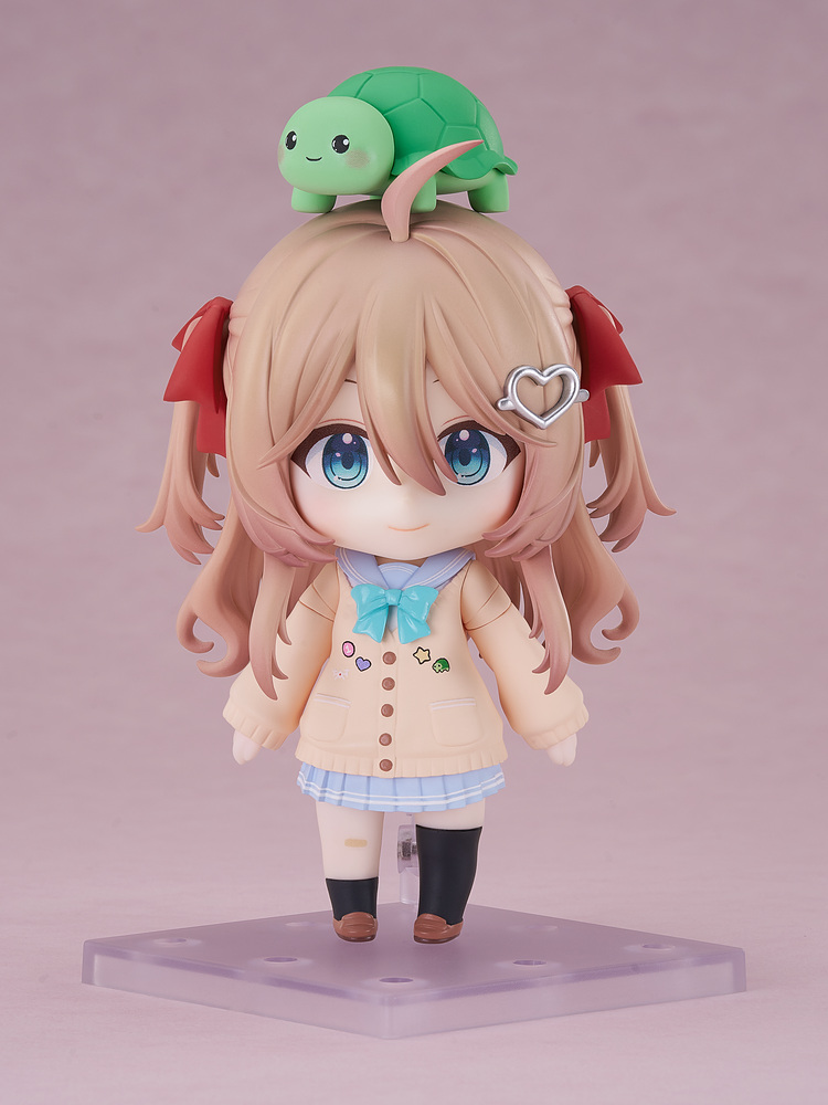 Nendoroid Neuro-sama standing on her clear display stand against a soft pink backdrop, with the green turtle Vedal part perched on her head