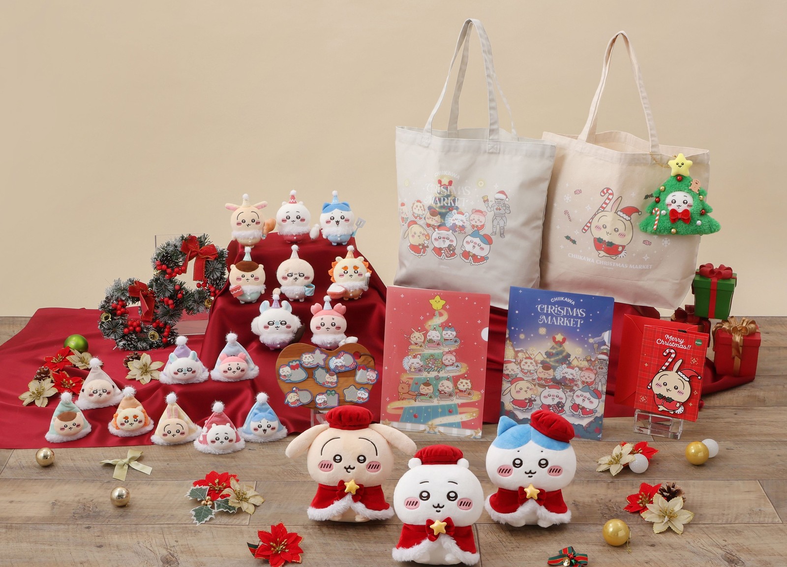 Line-up of Chiikawa Christmas Market plush, mascots, clear files and tote bags arranged on a festive wooden floor