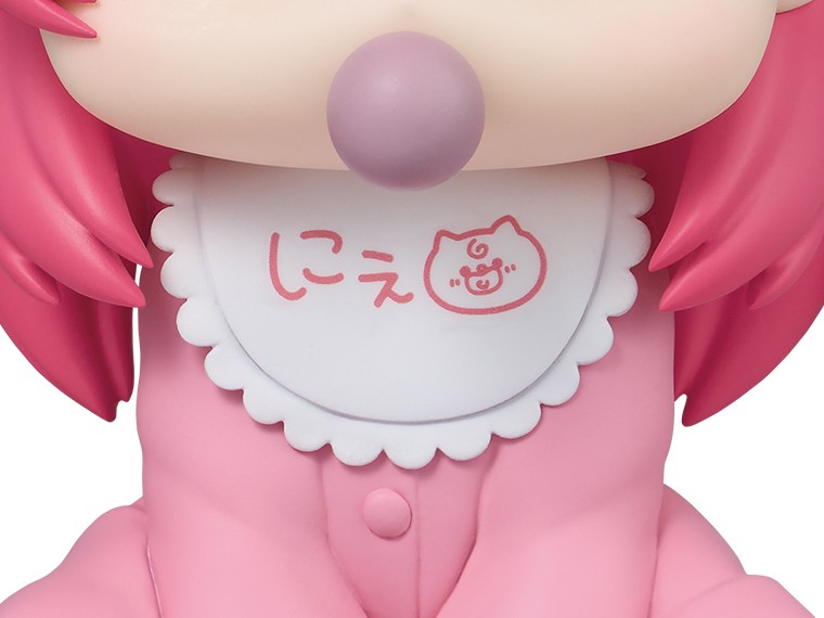 Close-up of the Holobabies Sakura Miko scalloped white bib printed with the replica handwritten message and cat doodle, with the pacifier above