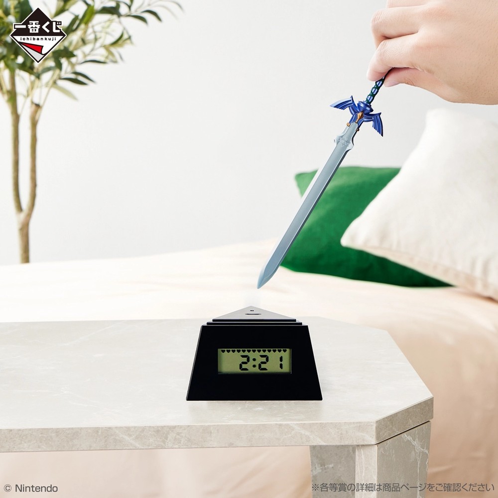 Hand pulling the Master Sword out of the Ichiban Kuji Zelda Hyrule Collection alarm clock