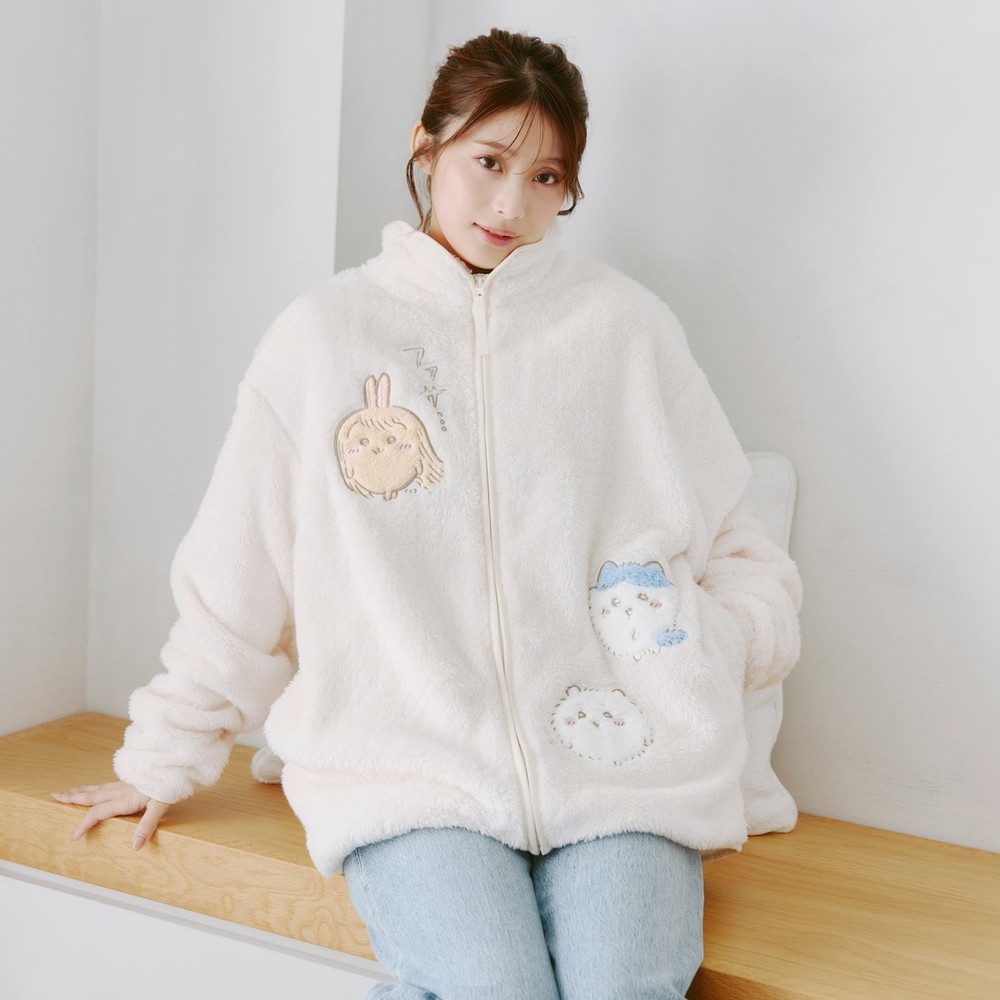 Model wearing the Chiikawa boa blouson fleece jacket with small embroidered characters