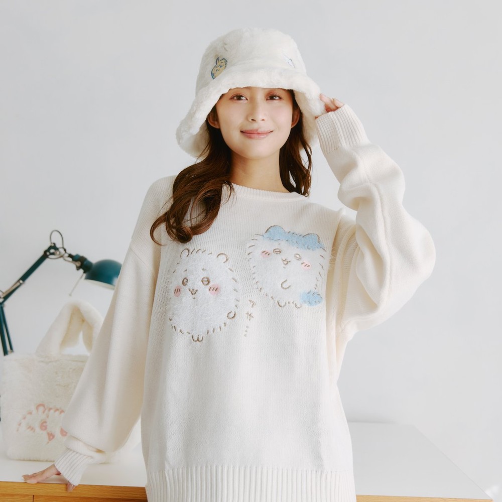 Model wearing a cream Chiikawa fluffy knit jumper with Chiikawa and Hachiware outlines