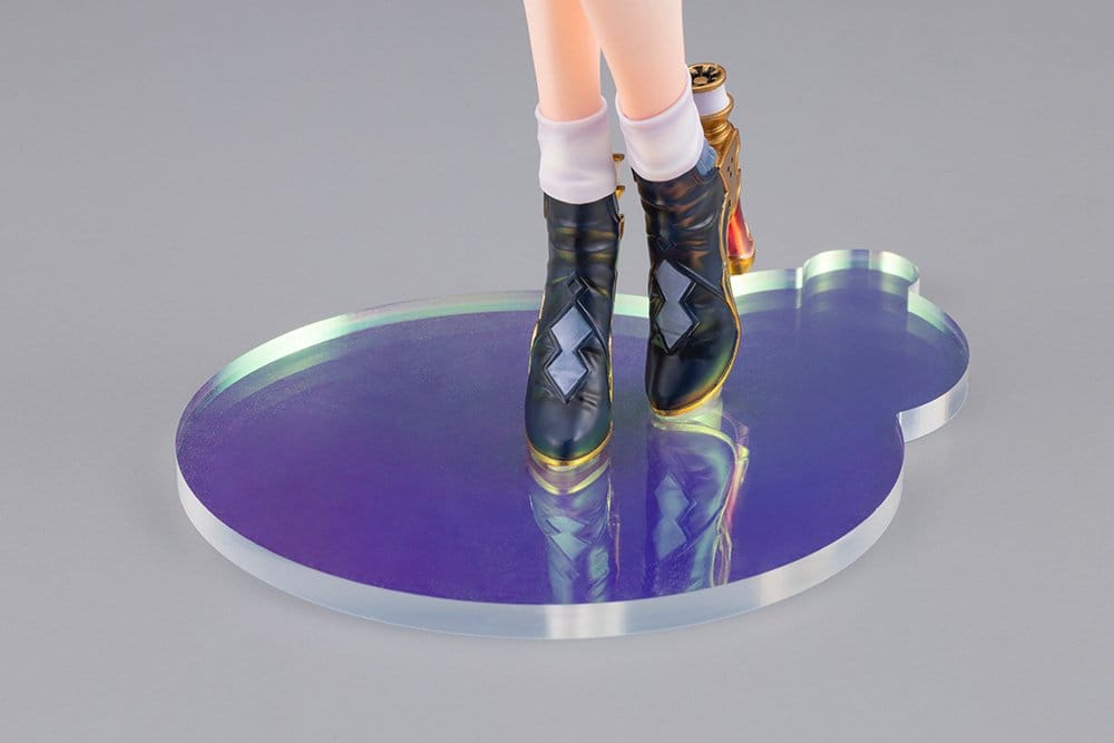 Close-up of the iridescent purple and blue puddle-shaped base with Yumia's black and gold boots