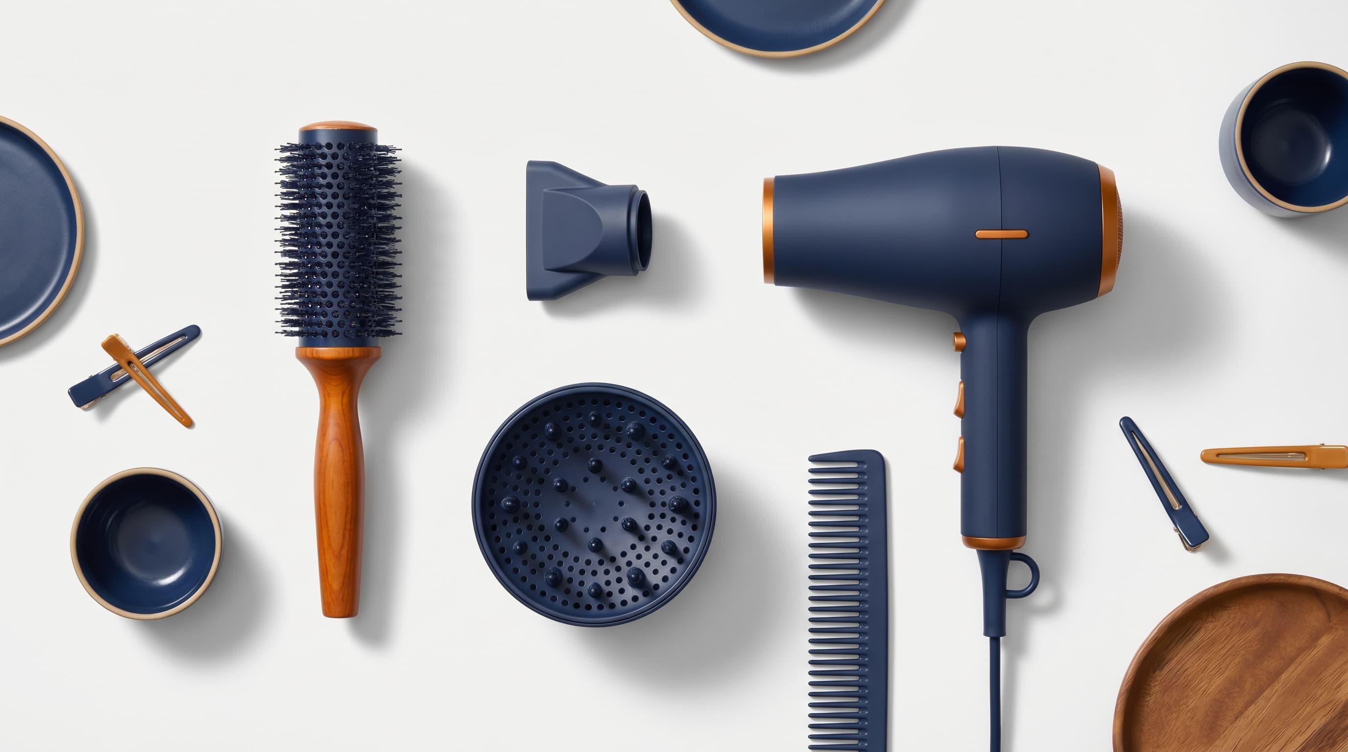 Blow drying tools laid flat &mdash; round brush, diffuser, concentrator nozzle, and dryer