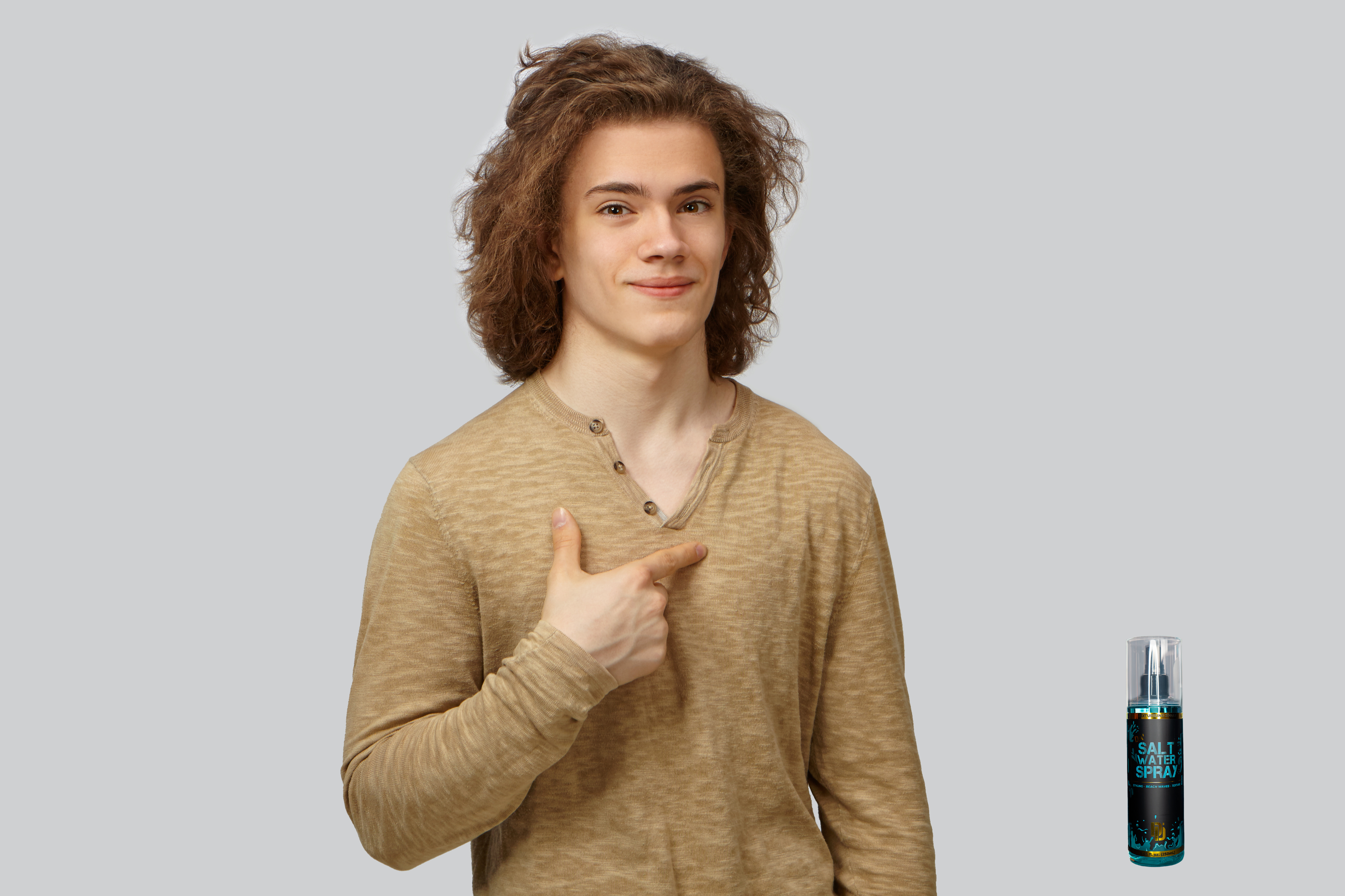 Confident man with long curly hair styled with Da'Salt Water Spray