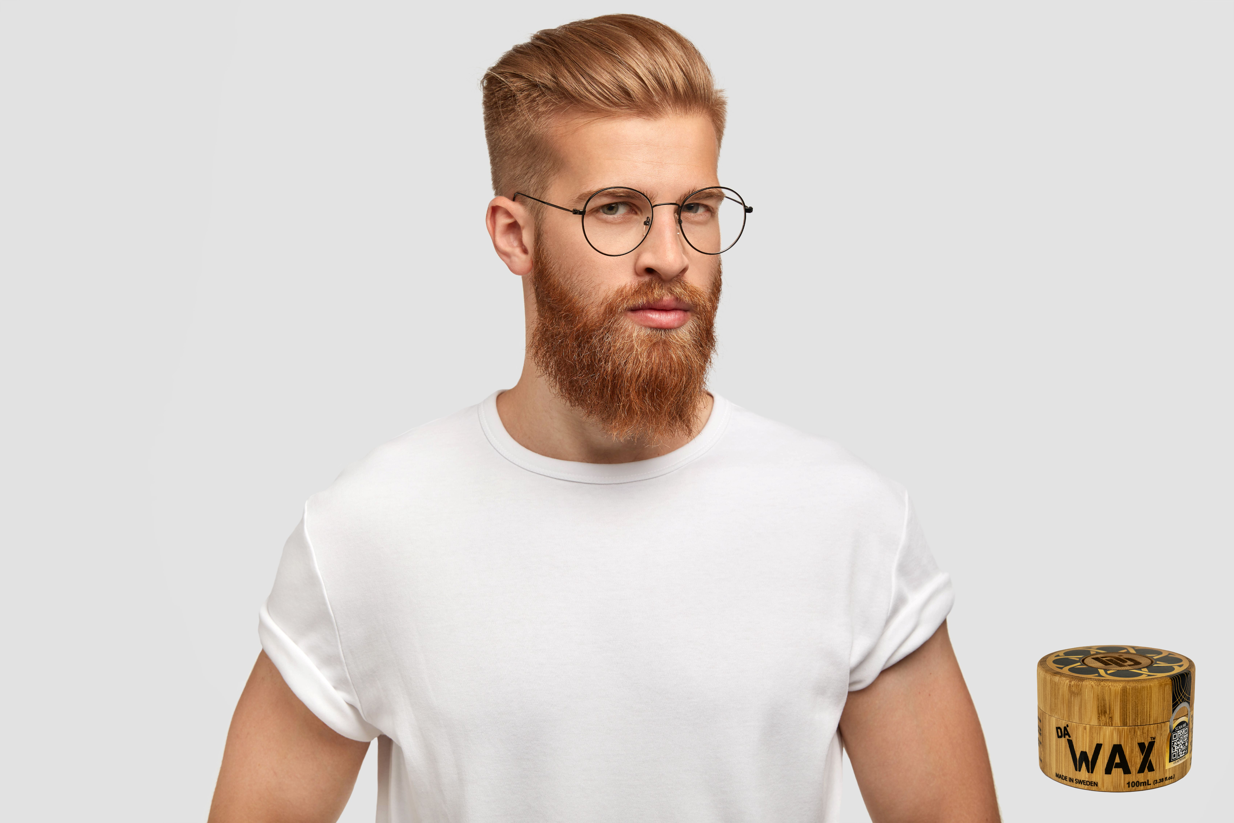 Stylish man in a casual white t-shirt wearing sunglasses sporting a modern pompadour hairstyle crafted with Da'Wax