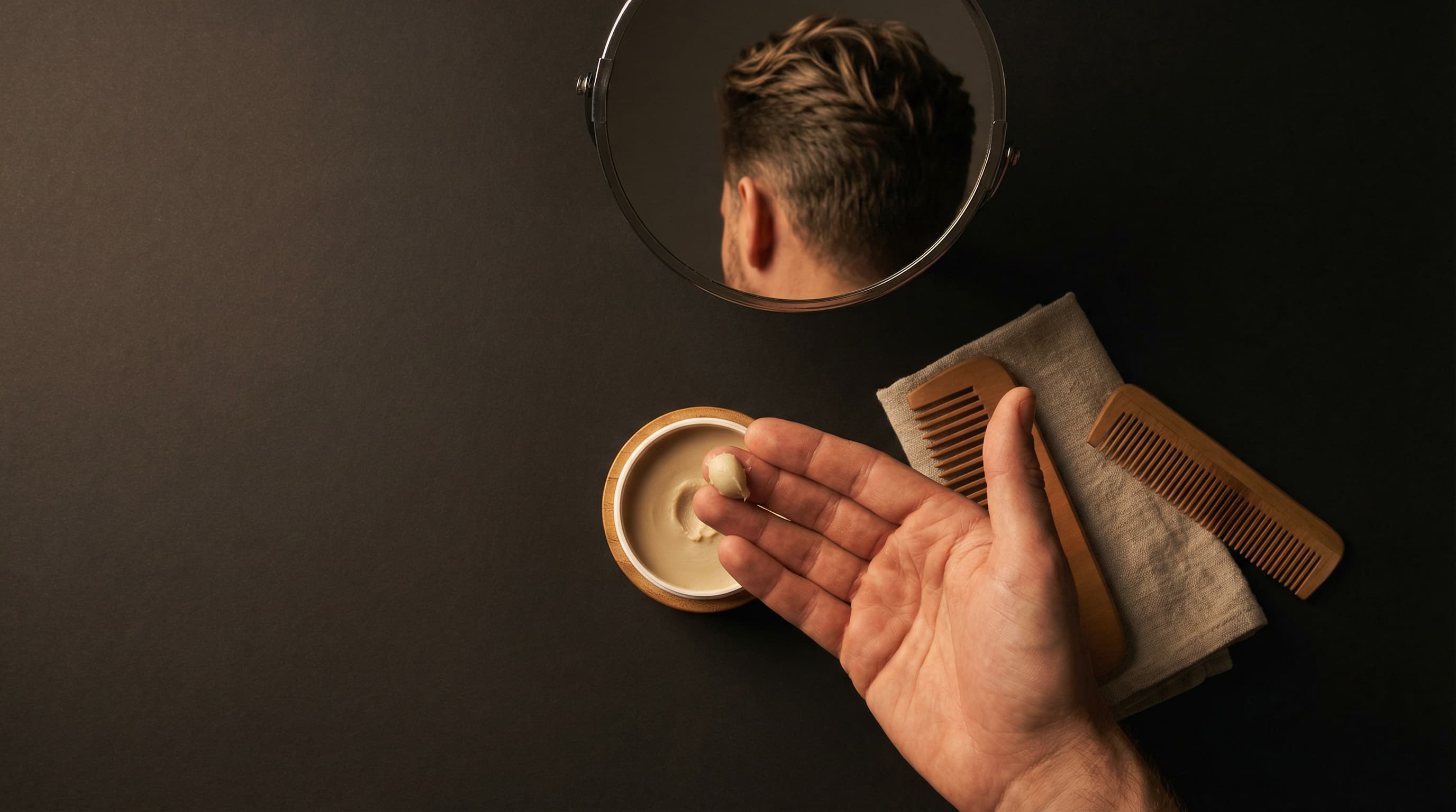 Applying pea-sized amount of matte finish hair wax for natural styling results