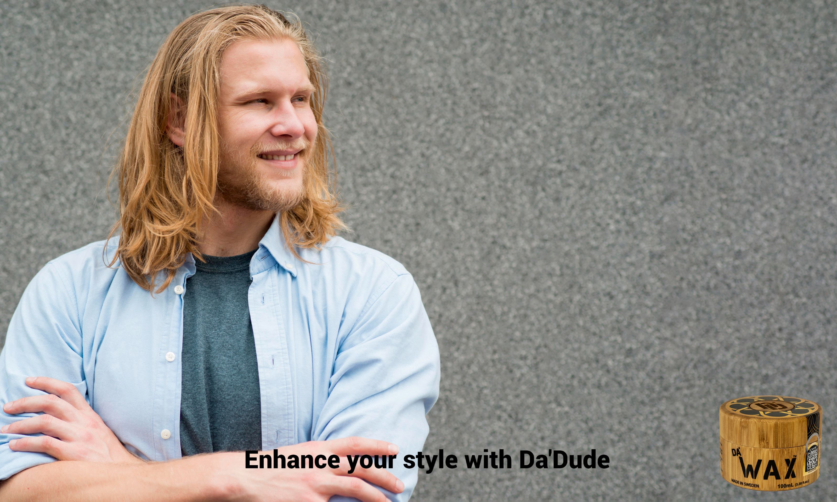Confident blonde man with long flowing hair styled with Da'Dude Da'Wax for natural matte finish