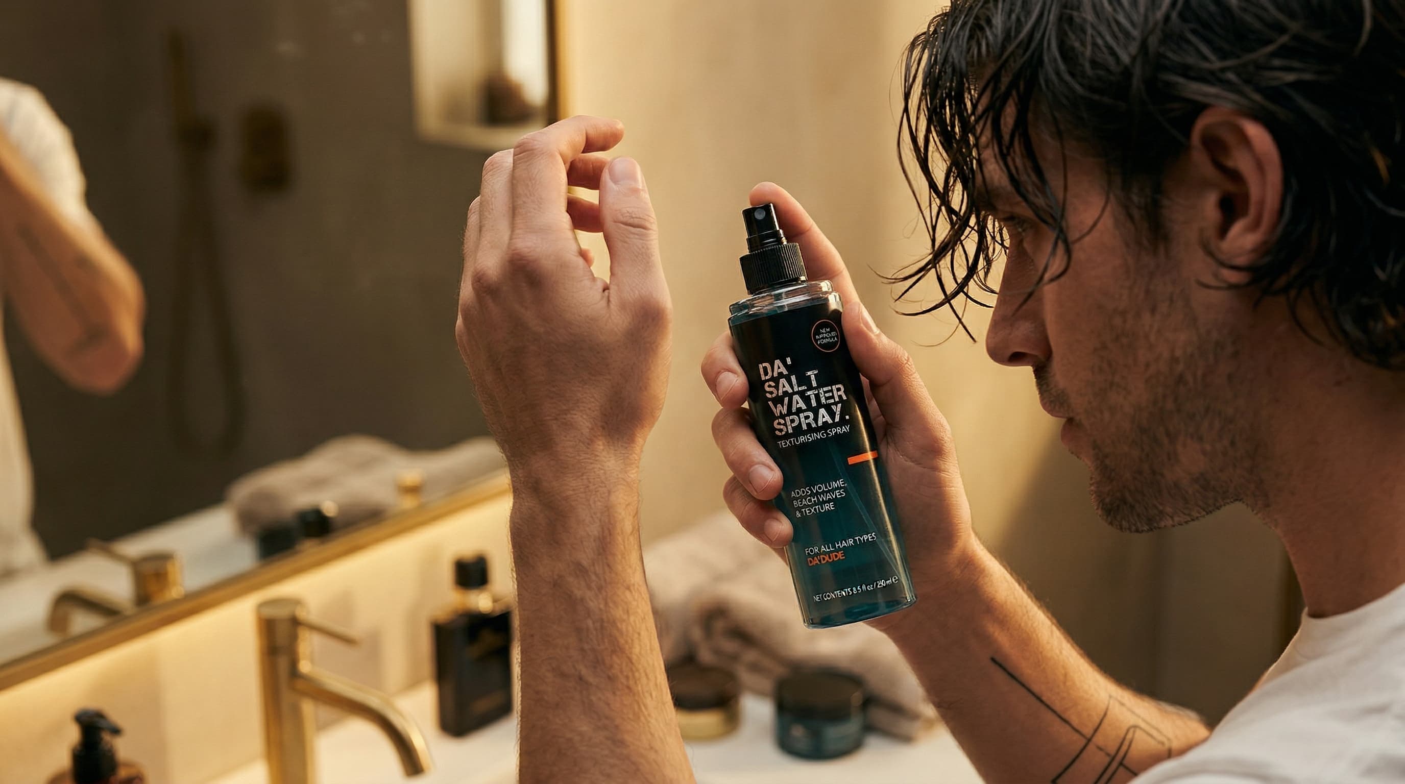 Man applying Da'Salt Water Spray to create textured men's hairstyle with strong hold and natural finish