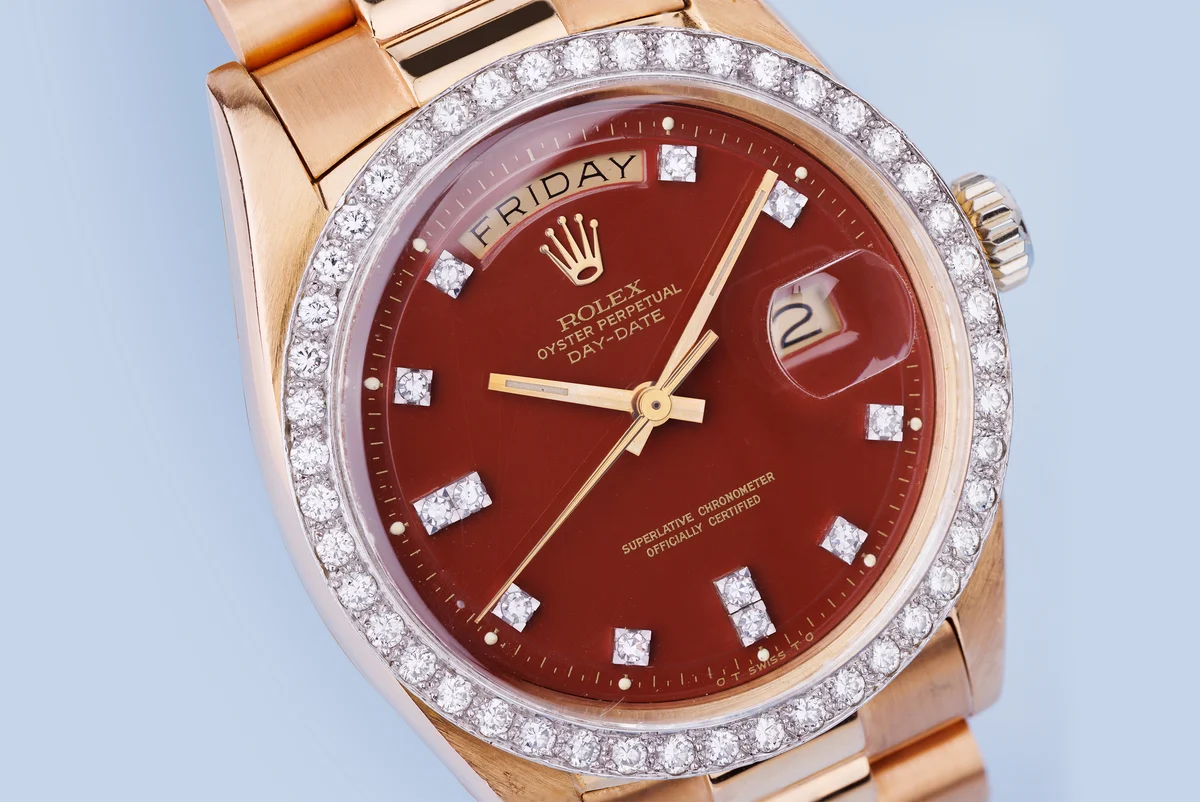Rolex Day-Date | Ref. 1804 | Quadrante bordeaux “Stella” | Rari doppi indici con diamanti e lunetta con diamanti | Oro rosa e oro bianco 18 carati | 1973 ([Chrono24][1])  [1]: https://www.chrono24.com.au/rolex/day-date--ref-1804--oxblood-red-stella-dial