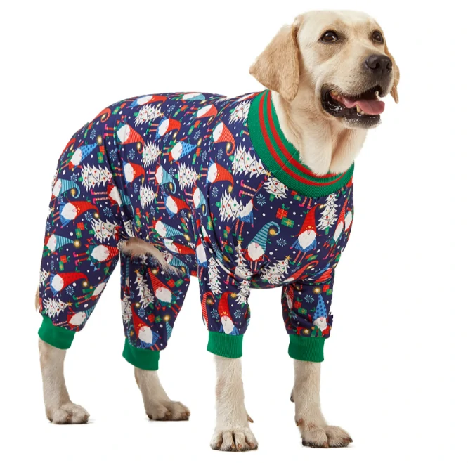 Labrador in blue holiday pajamas with Santa, Christmas trees, and candy cane patterns, accented with green collar and cuffs.