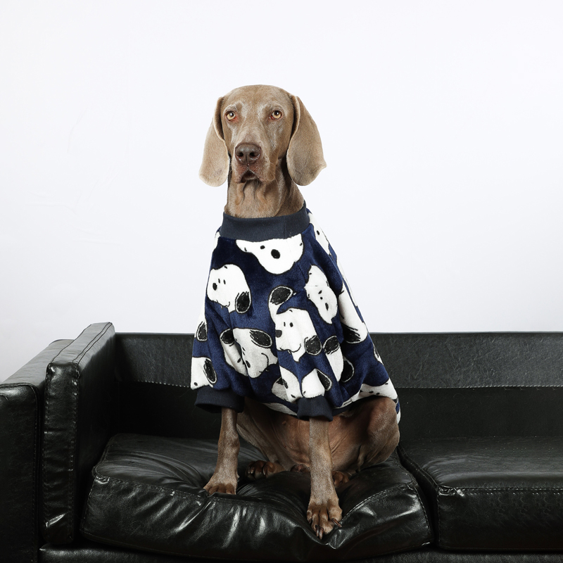 Large dog in Lovinpet navy blue fleece pajamas with a panda design, sitting on a black couch, providing warmth and comfort for large breeds.