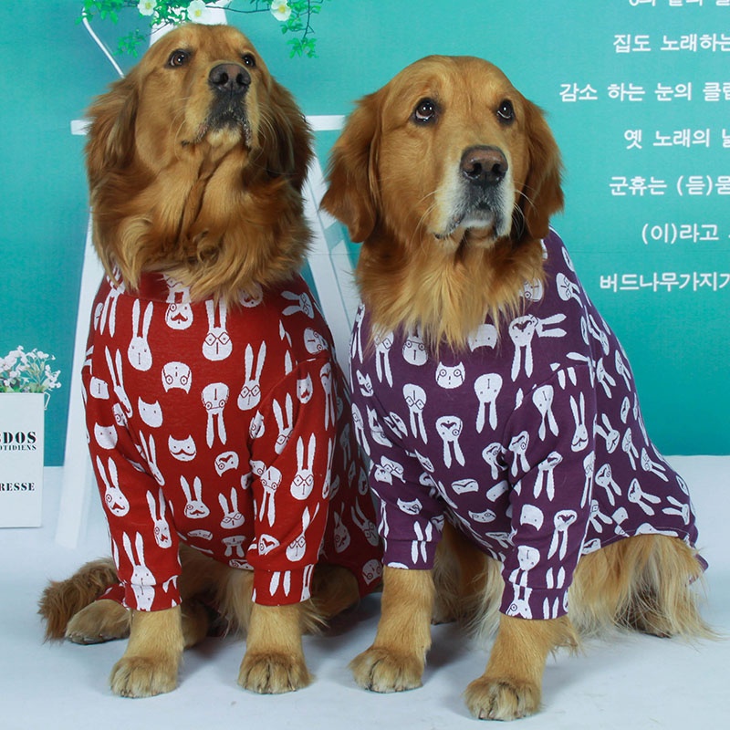 Two Golden Retrievers wearing Lovinpet cotton dog pajamas, one in red and the other in purple, both featuring a white rabbit pattern, showcasing comfort and style for large dogs.