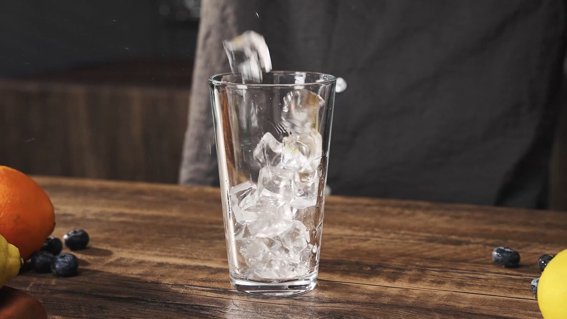 Clear ice cubes being added to a glass for better drink quality