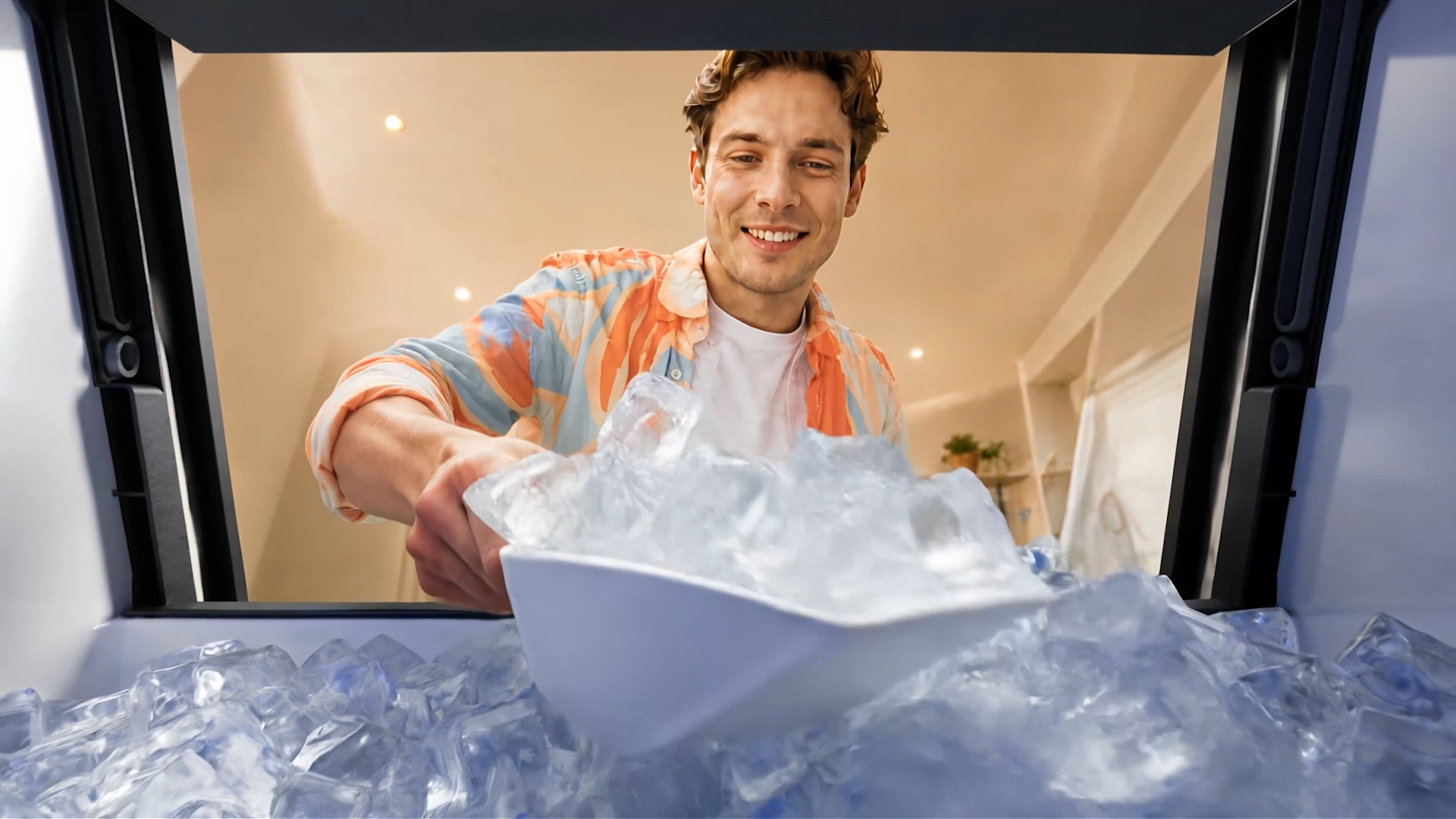 Fresh clear ice being scooped from a clean undercounter ice maker
