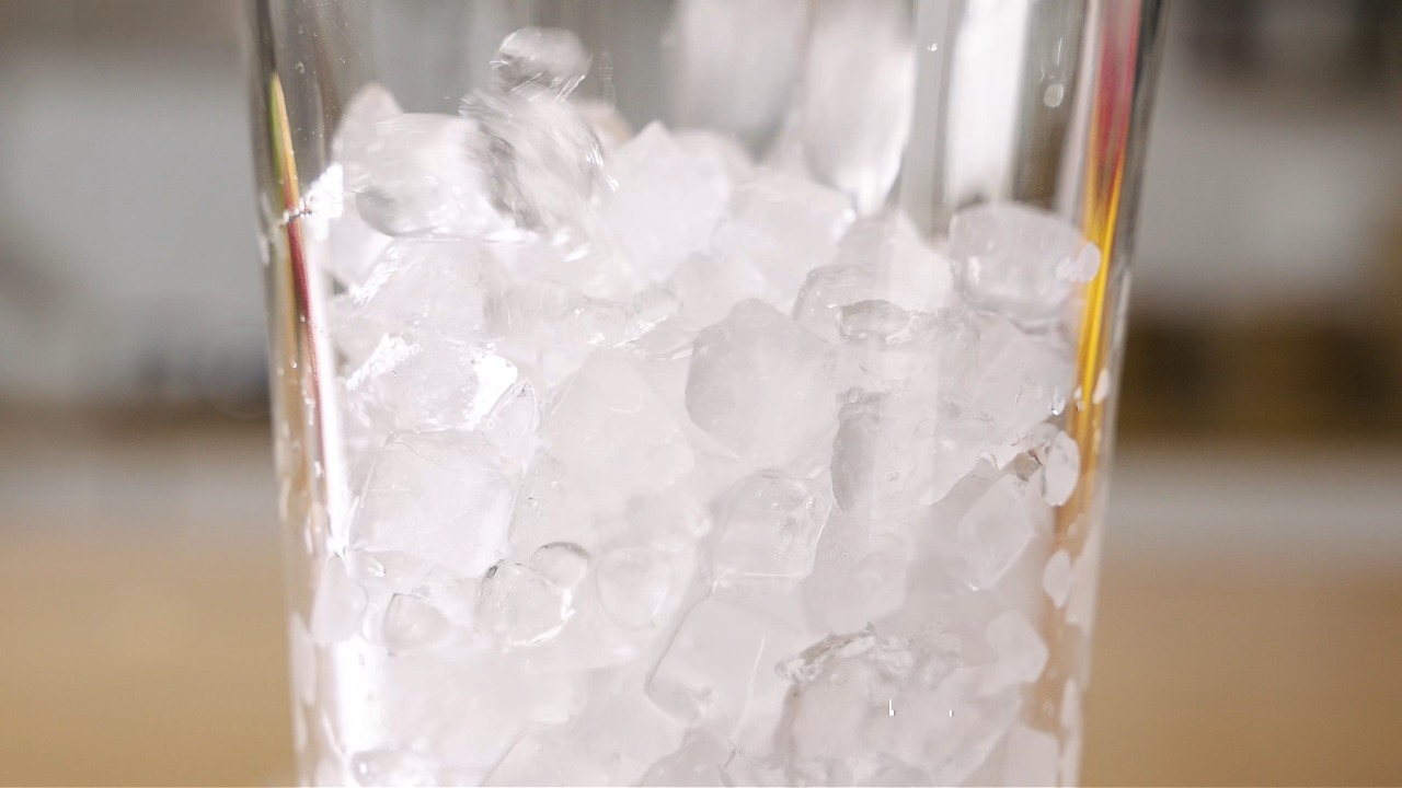 Close-up of soft chewable nugget ice filling a glass, showing porous texture