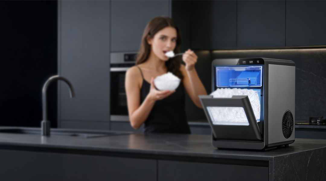 {"default":"Mojgar nugget ice maker produces chewable, pellet-style ice, featured with a person enjoying a bowl of ice in a sleek kitchen."}
