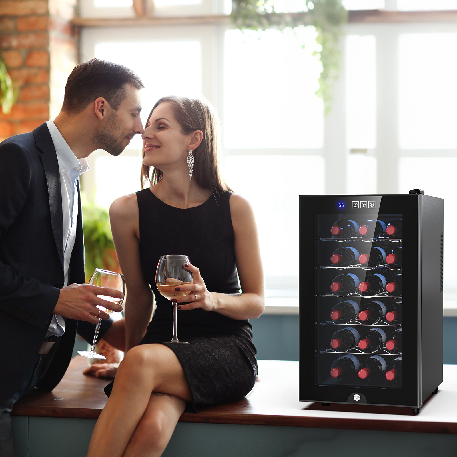 A couple enjoying wine with an 18-bottle wine cooler in the background, showcasing a sleek design and ideal for gifting, enhancing romantic and special occasions.
