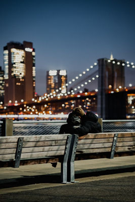 Couple on a bench with bridge in background