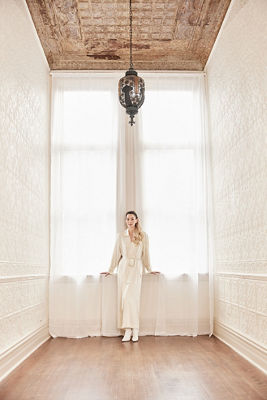 Person Standing Posing in Front of a Window