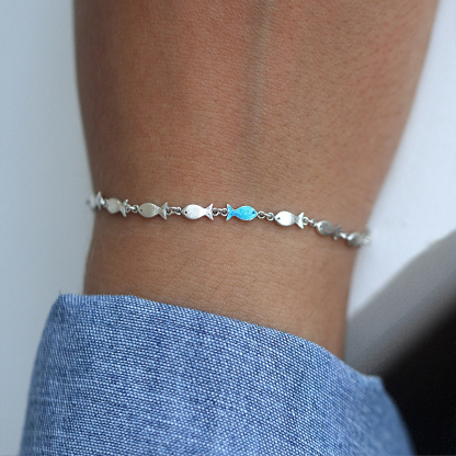 Swimming Against The Current Fish With One Blue Bracelet