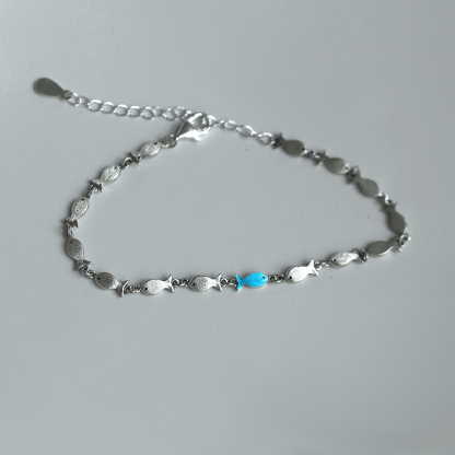 Swimming Against The Current Fish With One Blue Bracelet